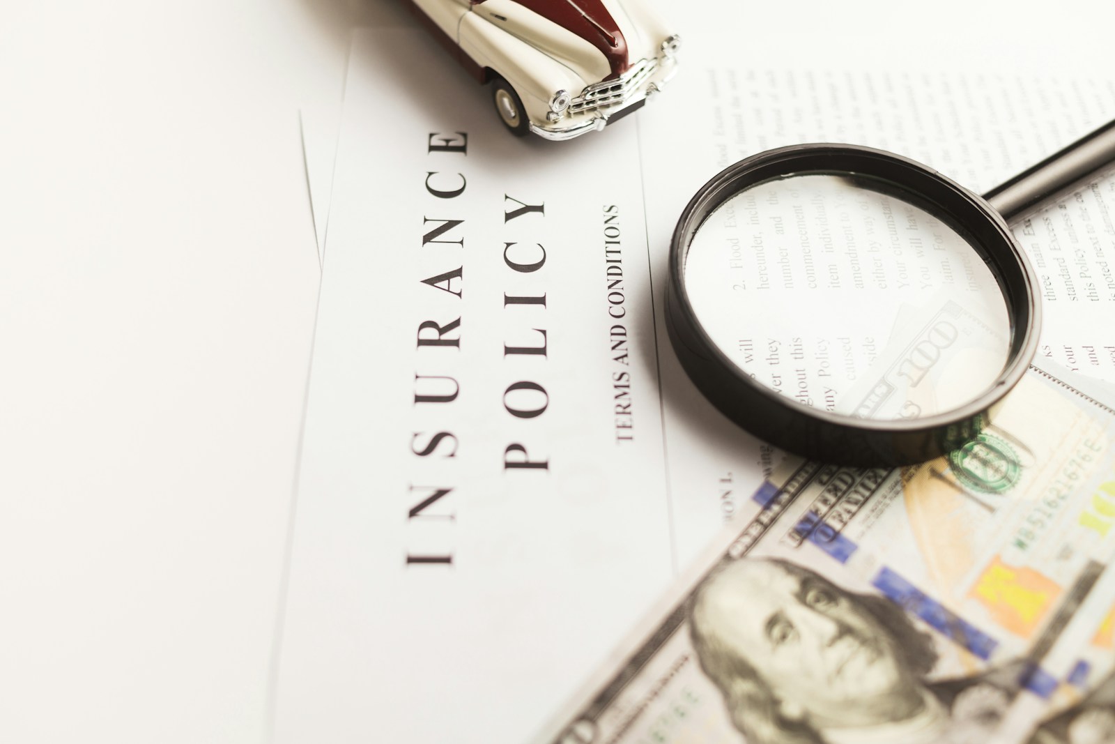 Photo by Vlad Deep a magnifying glass next to a car and money